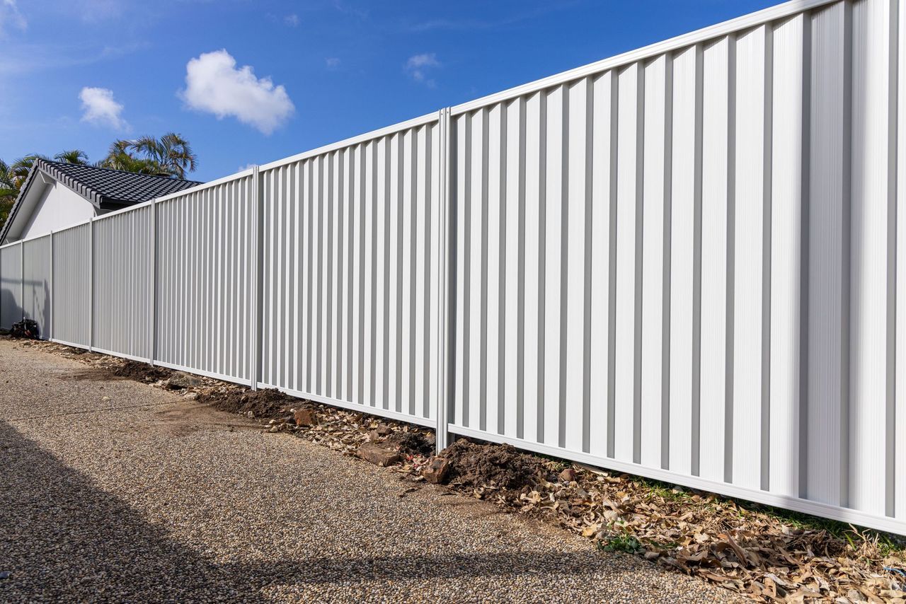 Long run of Colorbond steel boundary fencing